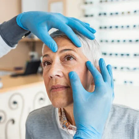 An optometrist examining a patient's eyes for dry eye syndrome