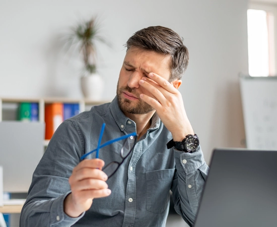 A man rubbing at his itchy, dry eyes